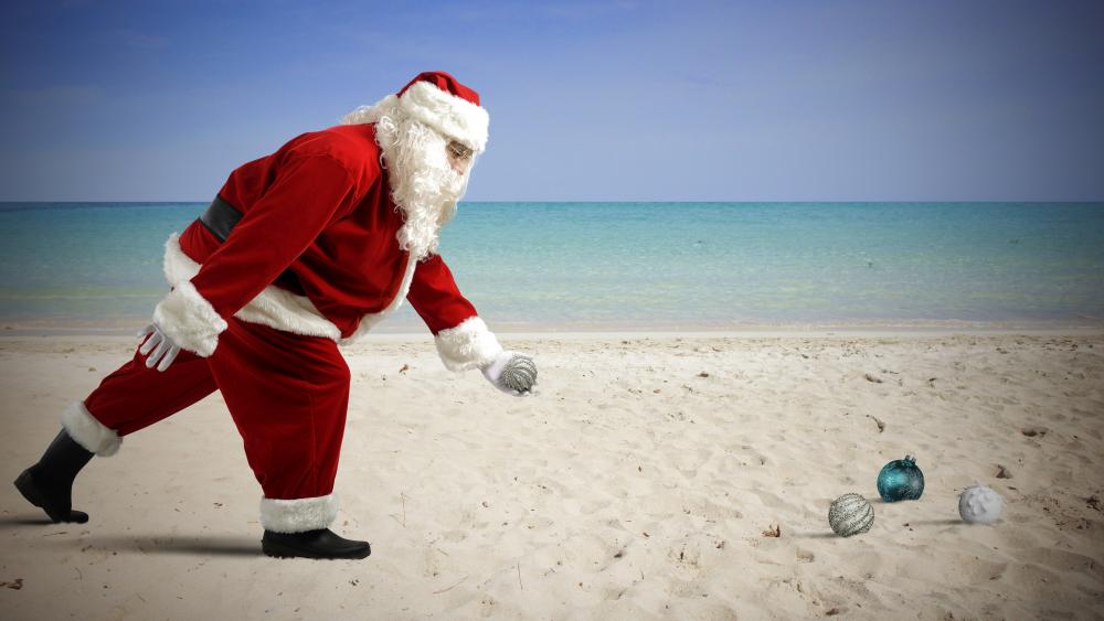 Santa playing on the sandy beach wallpaper