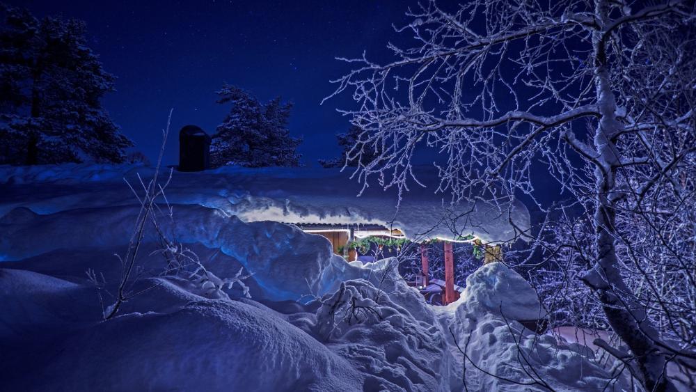 Christmas lights on a snowy cabin wallpaper