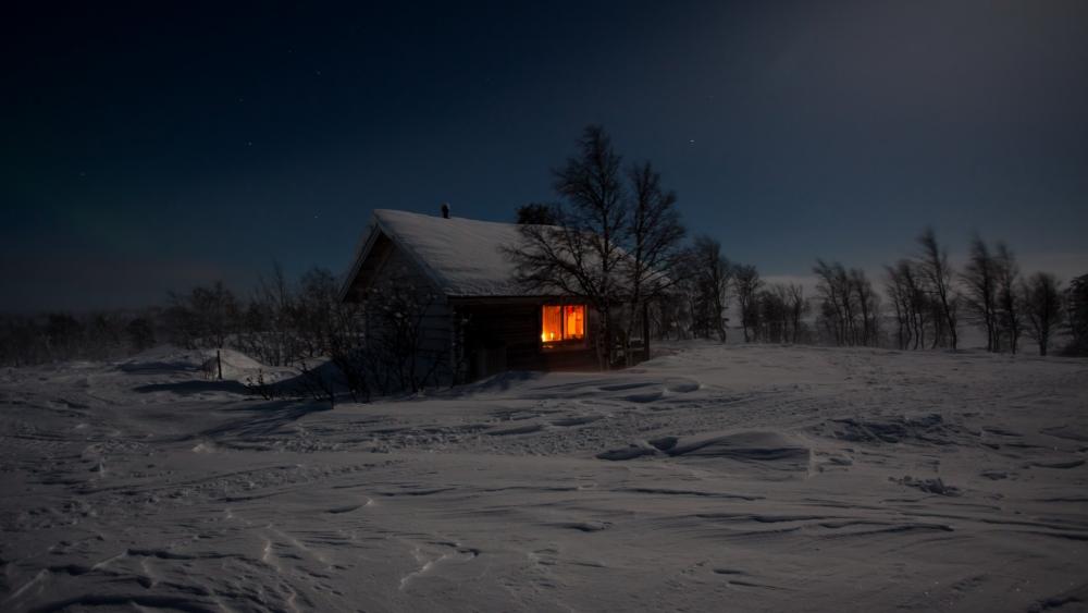 Solitary snowy house at winter night wallpaper