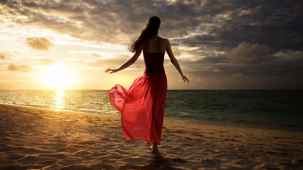 Woman in red dress on the beach wallpaper