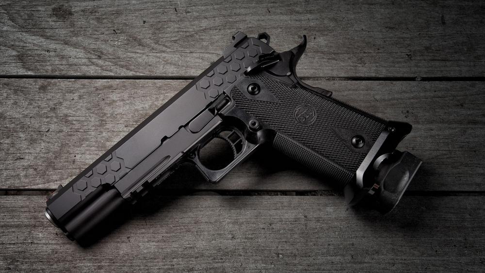 Sleek Handgun on Wooden Surface wallpaper