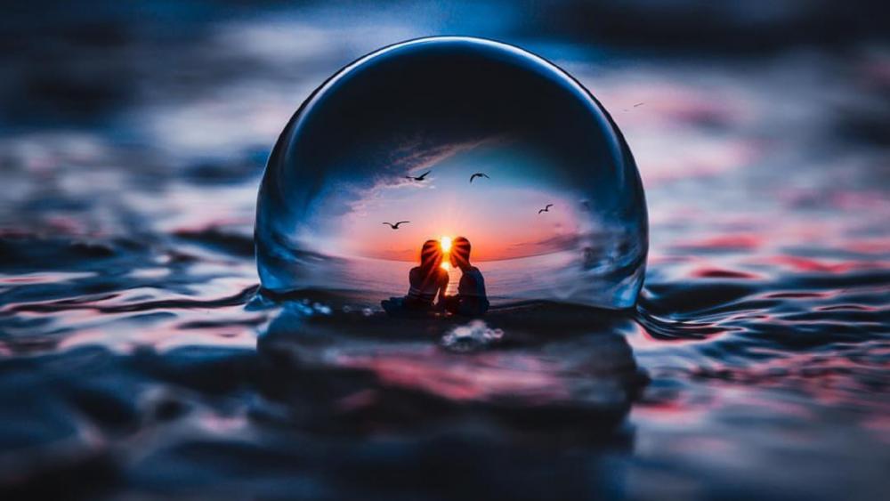 Loving couple in a crystal ball wallpaper