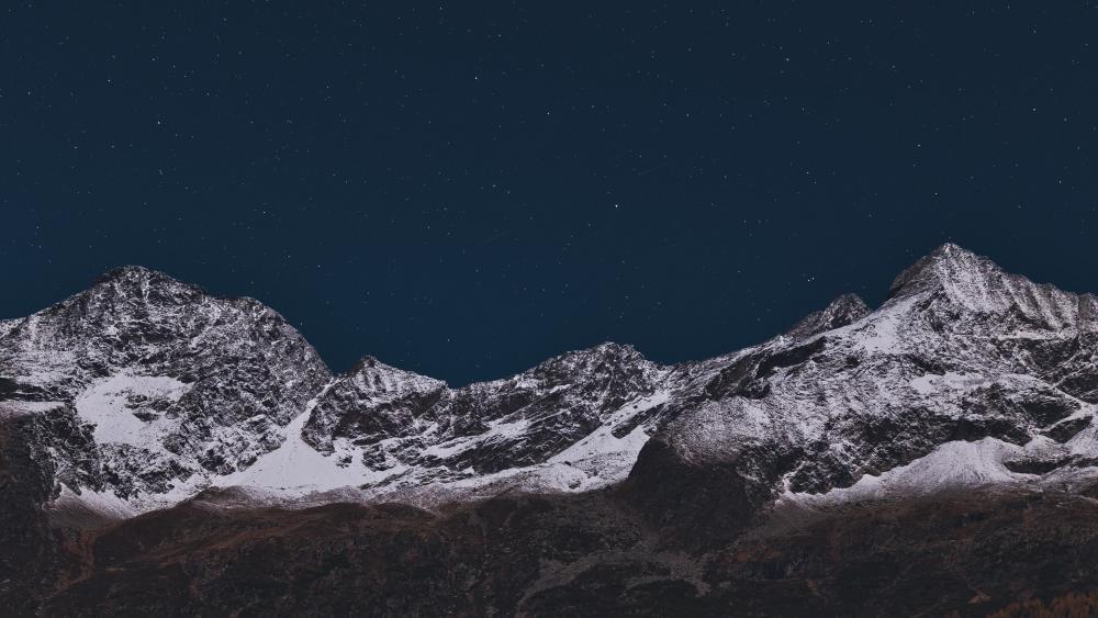 Starry sky over the rugged mountains wallpaper