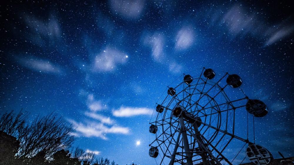 A Ferris wheel and the starry night sky wallpaper