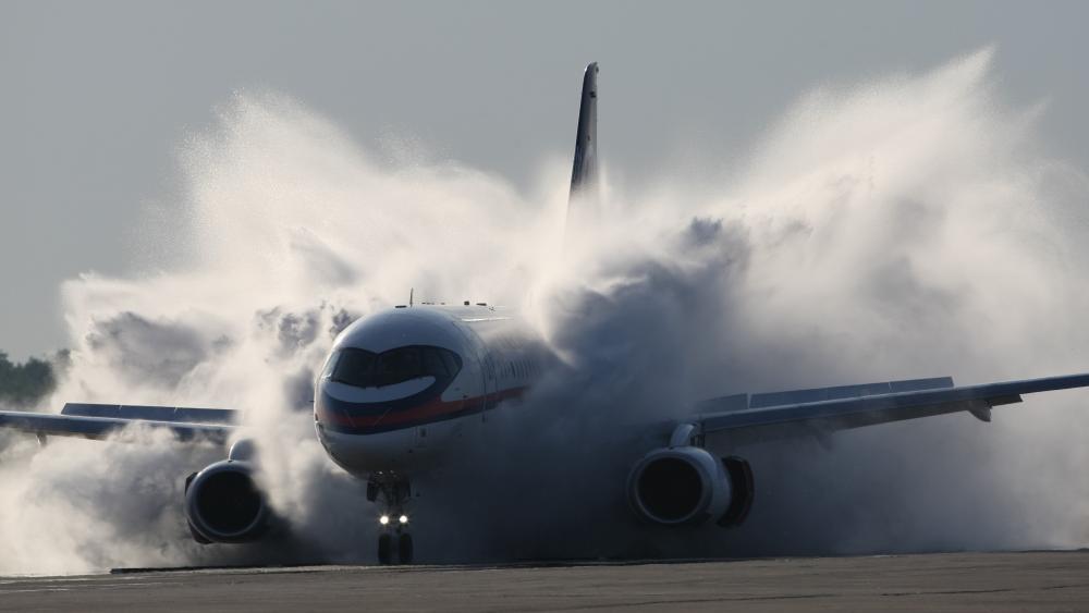 Boeing Jet Powering Through Intense Takeoff Spray wallpaper