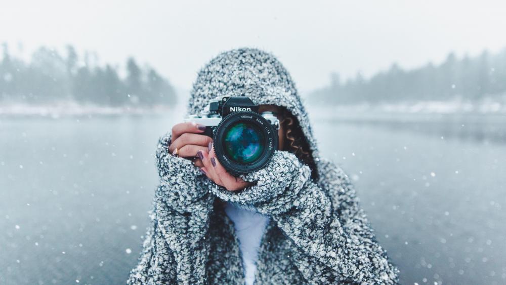 Photographer woman in the snowfall wallpaper