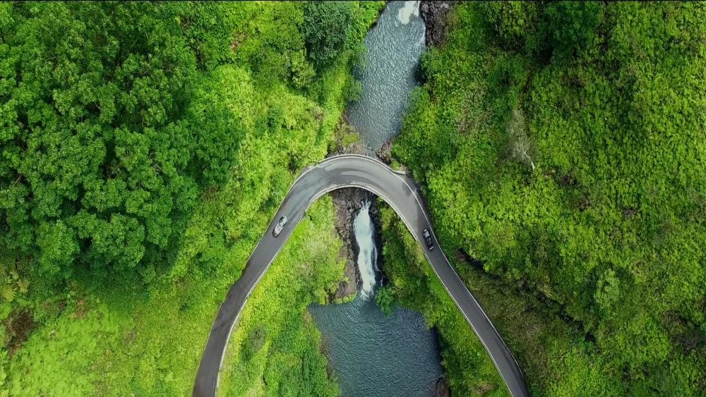 Waterfall under the road drone view wallpaper