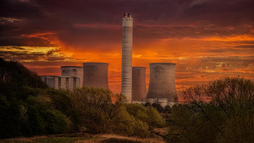 Industrial sunset against a vibrant sky and cooling towers wallpaper