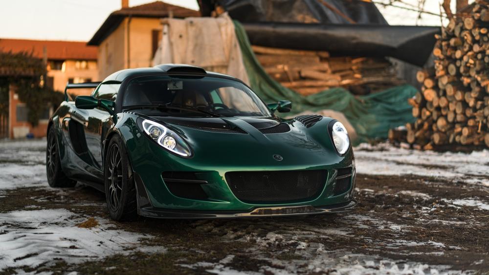 Sleek Green Supercar in Rural Setting wallpaper