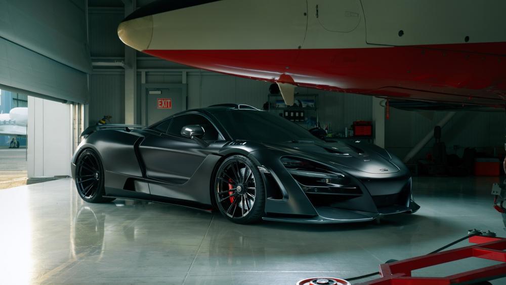 Sleek Supercar in Aircraft Hangar wallpaper