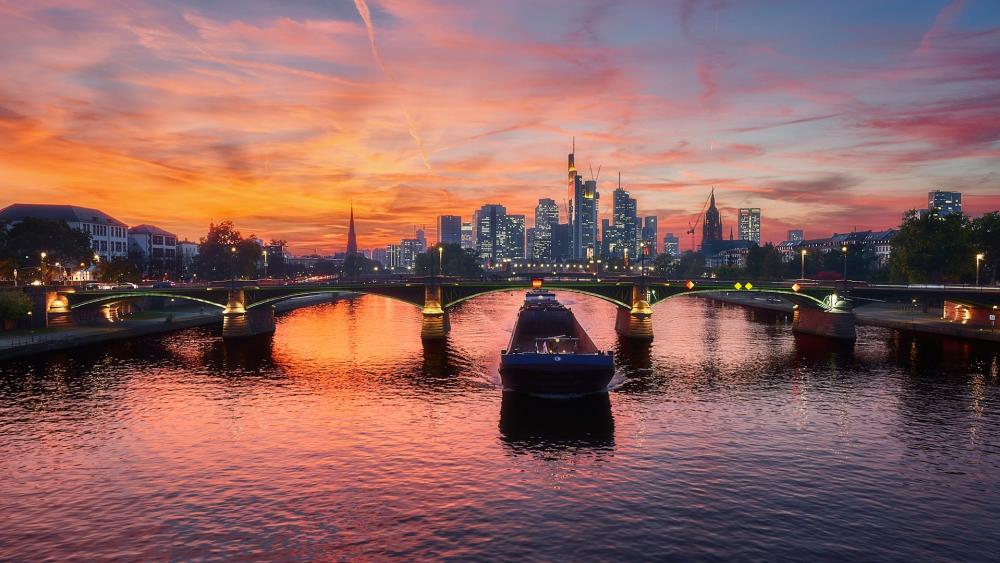 Vibrant Sunset Over a City Skyline and River Scenery wallpaper