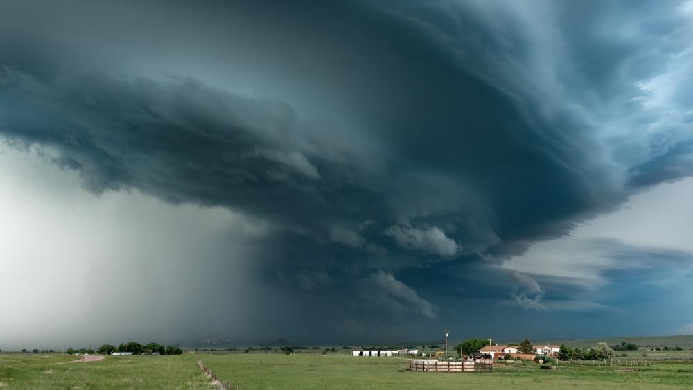 Dramatic Skies Over Rolling Fields wallpaper