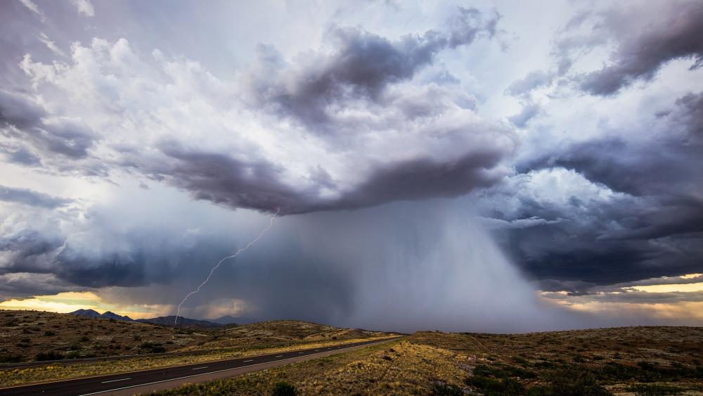 Dramatic Thunderstorm Over Open Landscape wallpaper