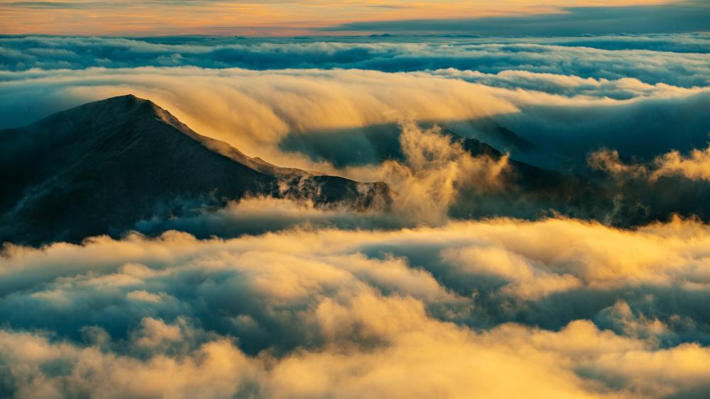 Majestic Mountain Peaks Above the Clouds wallpaper