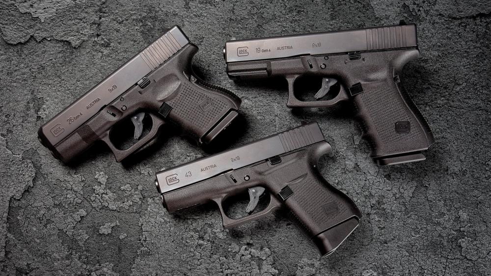 Glock Pistols Display on Concrete Surface wallpaper