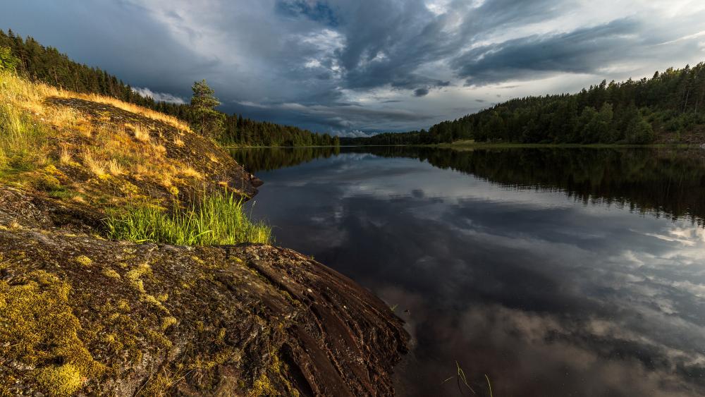 Tranquil Lake Under Dramatic Skies wallpaper