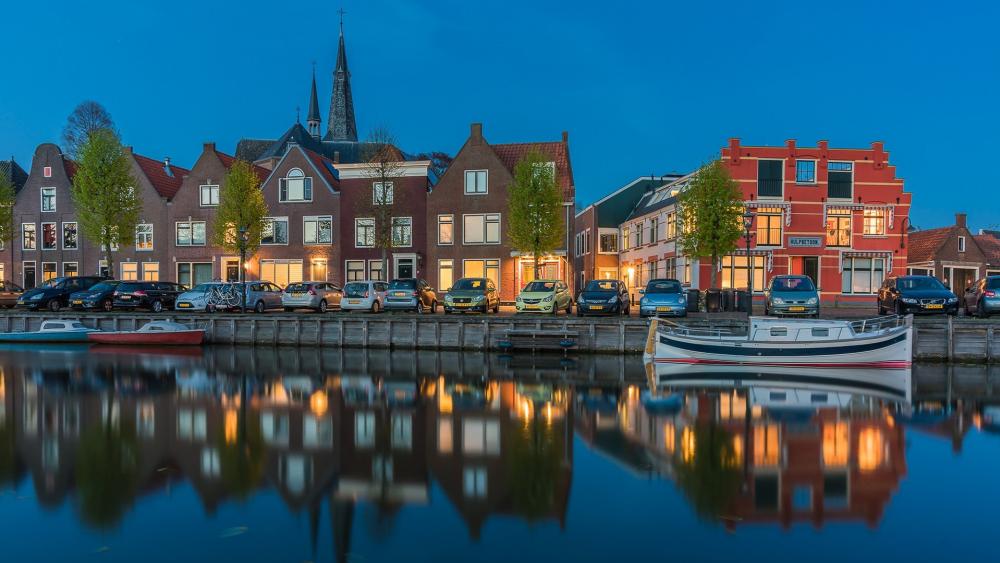 Charming Canal Views at Twilight Overlooking a Historic Cityscape wallpaper