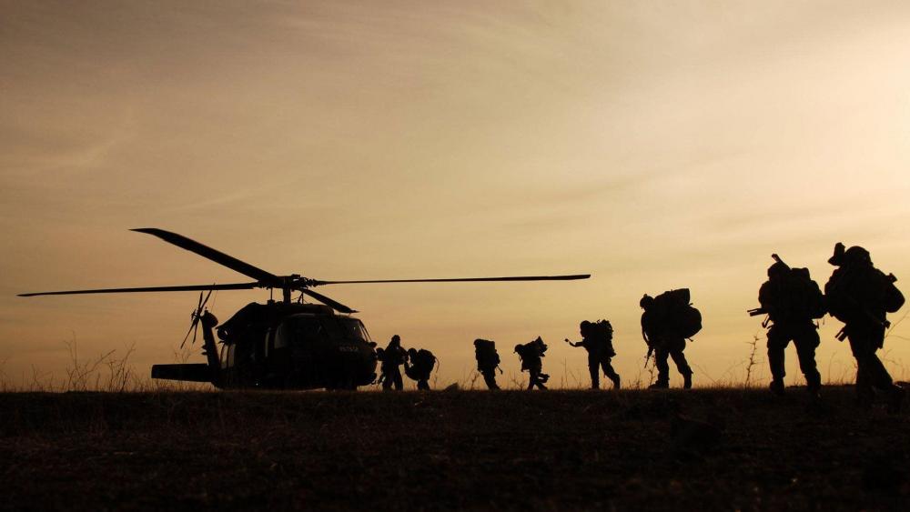 Military Helicopter and Soldiers at Dusk wallpaper