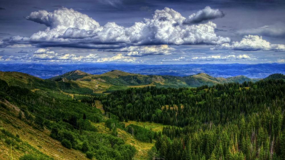 Breathtaking Mountain Landscape Under Dramatic Skies wallpaper