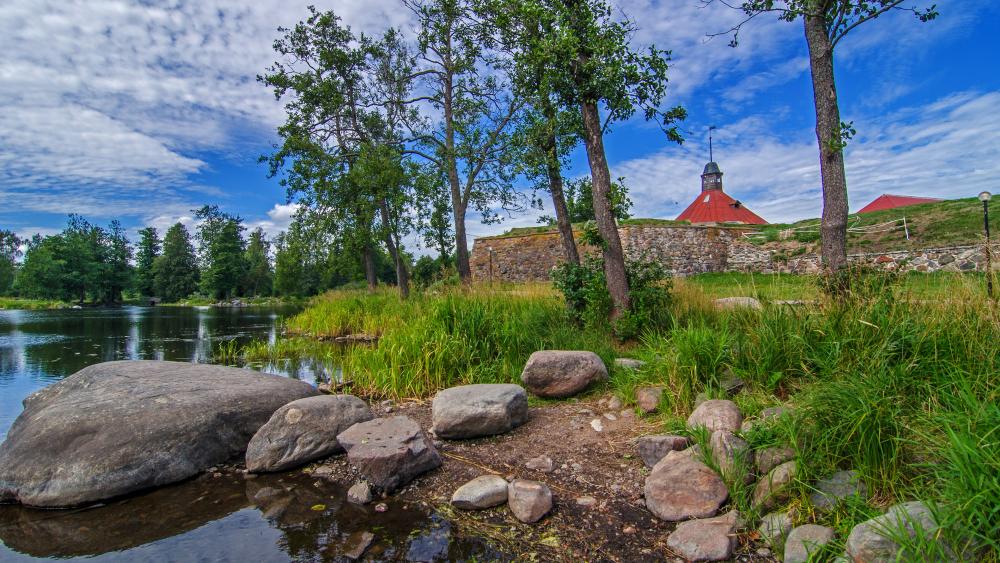 Fortress by the Riverbank in Summer Serenity wallpaper