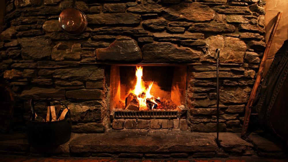 Cozy Stone Fireplace in Warm Ambiance wallpaper