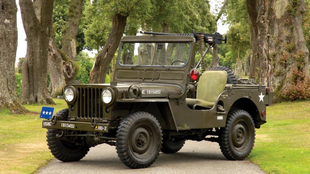 Vintage Military Jeep on Scenic Road wallpaper