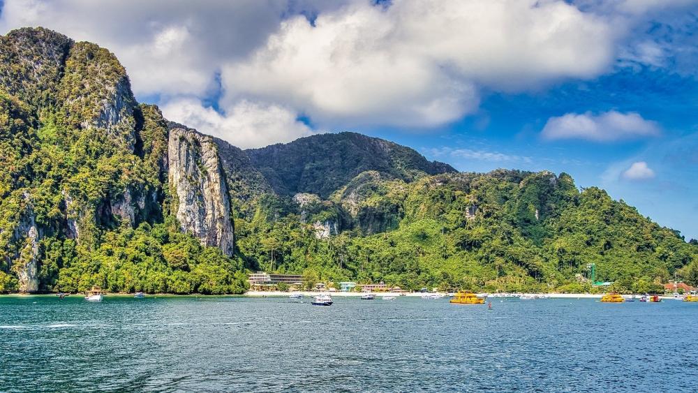 Serene Coastal Landscape with Majestic Cliffs and Vibrant Waters wallpaper