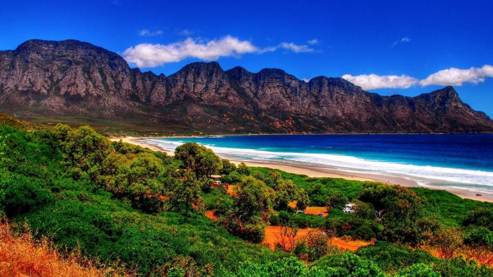 Majestic Coastal Landscape with Serene Waters and Mountains wallpaper