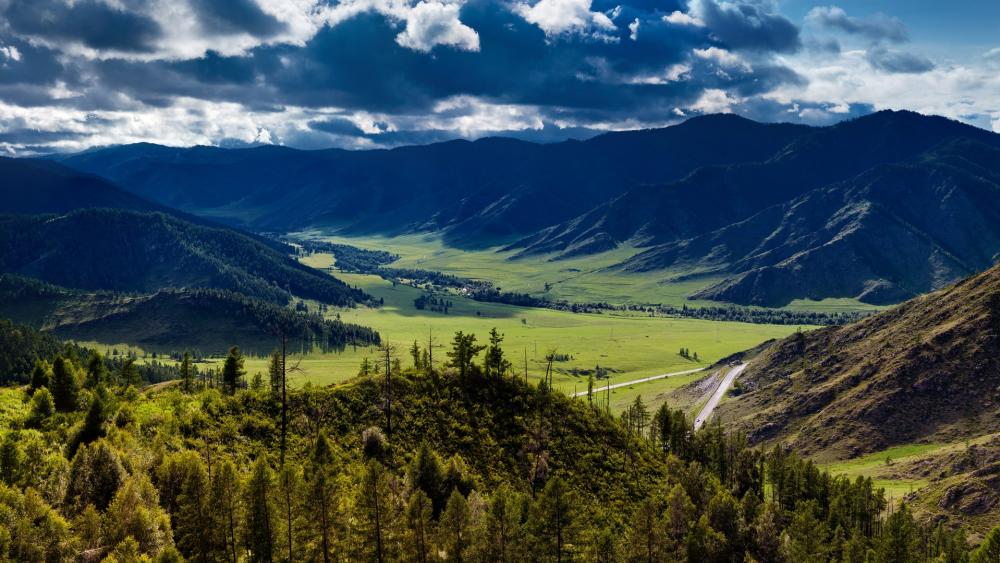 Breathtaking Mountain Valley Landscape Under Dramatic Sky wallpaper