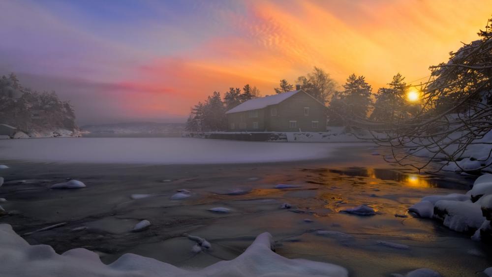 Serene Winter Sunset Over a Frozen Lake wallpaper
