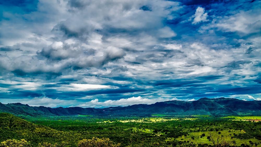 Majestic Sky Over Lush Green Landscape wallpaper
