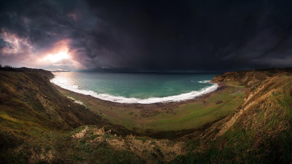 Stormy Coastal Beauty Through Calm Waters wallpaper