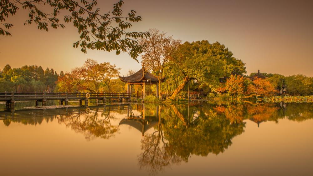Serene Autumn Landscape Reflection in Tranquil Water wallpaper