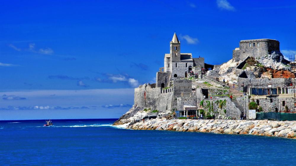 Historic Coastal Fortress in Vibrant Blue Waters wallpaper