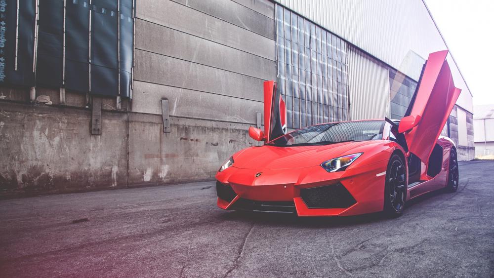 Sleek Red Lamborghini with Iconic Doors Up wallpaper