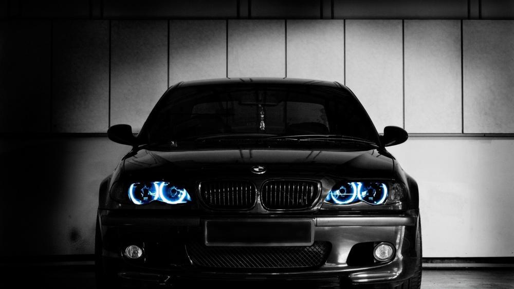 Sleek Black BMW with Striking Blue Headlights wallpaper
