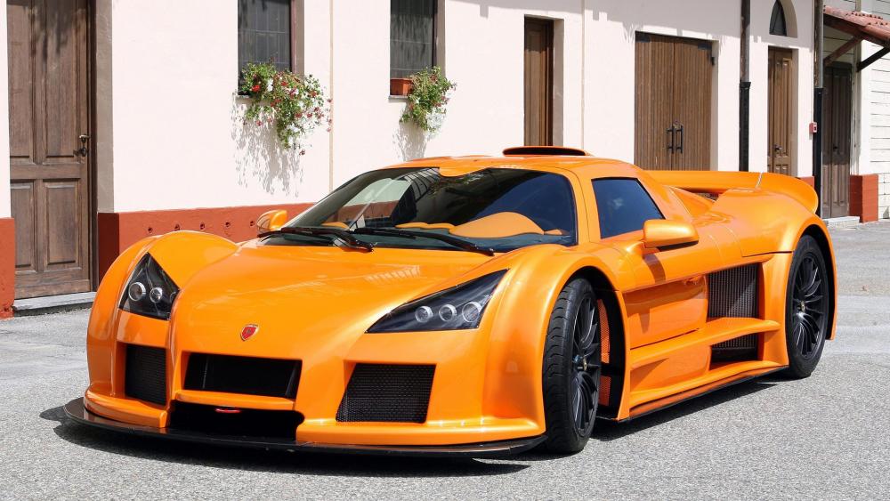 Stunning Orange Supercar on Display in the Sunlight wallpaper