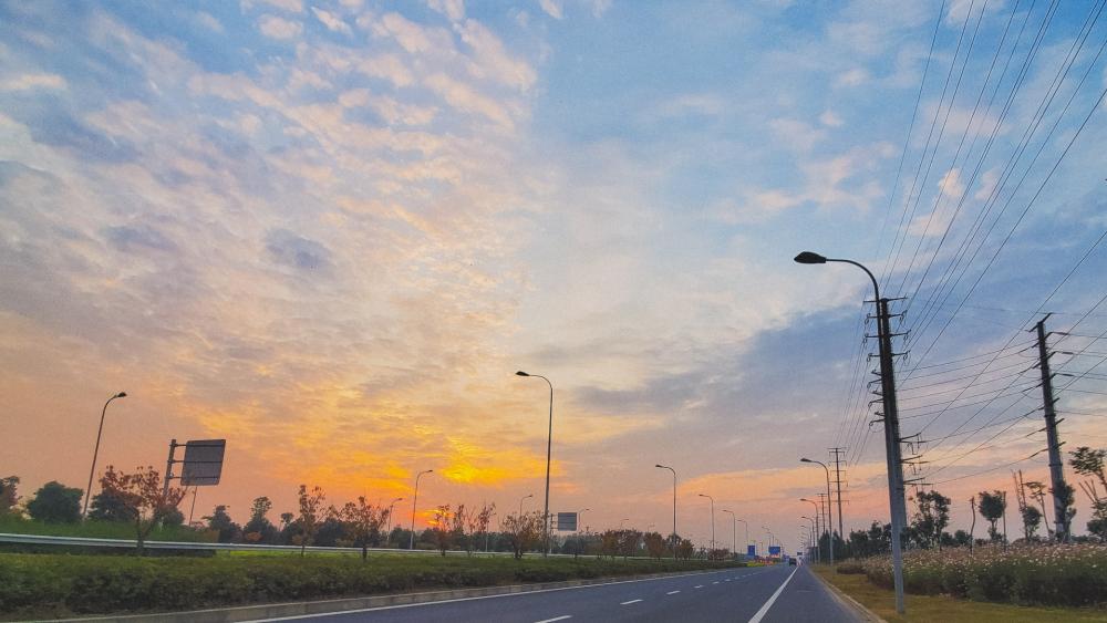 Serene Sunset Drive Through Nature's Canvas wallpaper