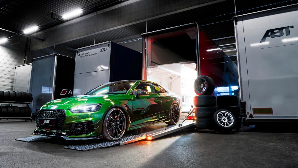 Sleek Green Sports Car in a Racing Garage wallpaper
