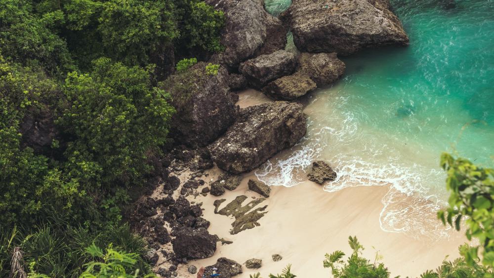 Aerial View of Secluded Bouldered Beach wallpaper