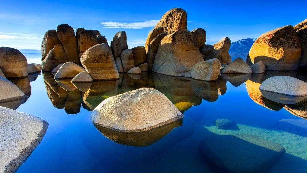 Tranquil Waters Amidst Majestic Boulders wallpaper