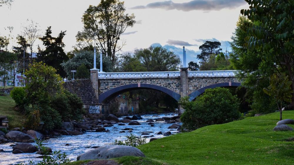 Tranquil Bridge Over Serene Stream wallpaper