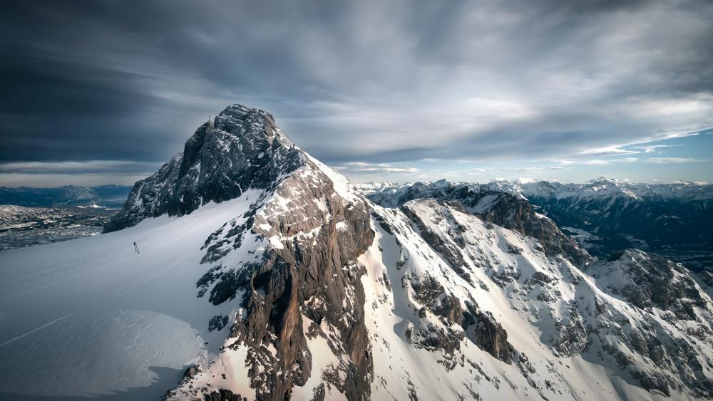 Majestic Snow-Capped Mountain Peaks in Twilight Light wallpaper