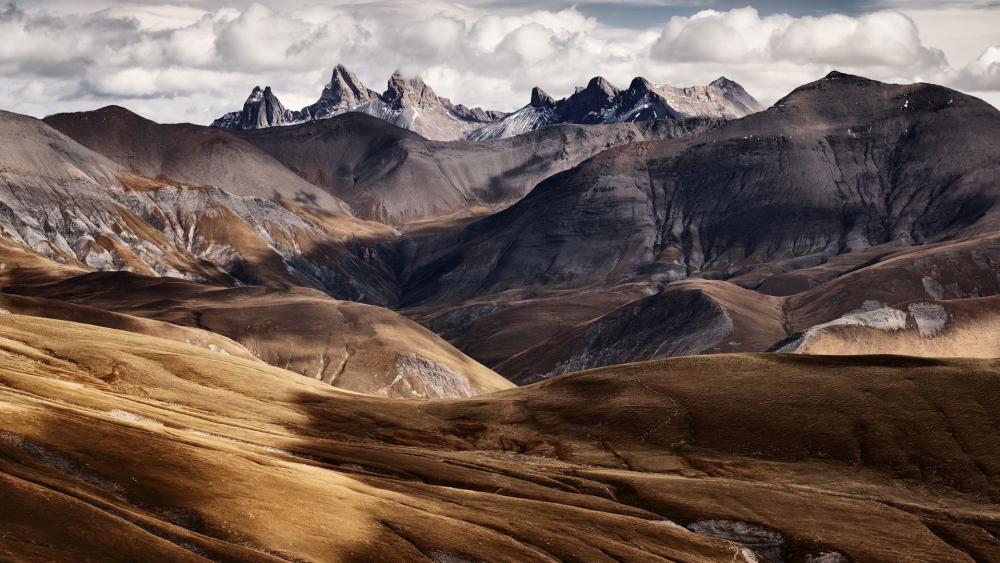Majestic Mountain Landscape Under Cloudy Skies wallpaper