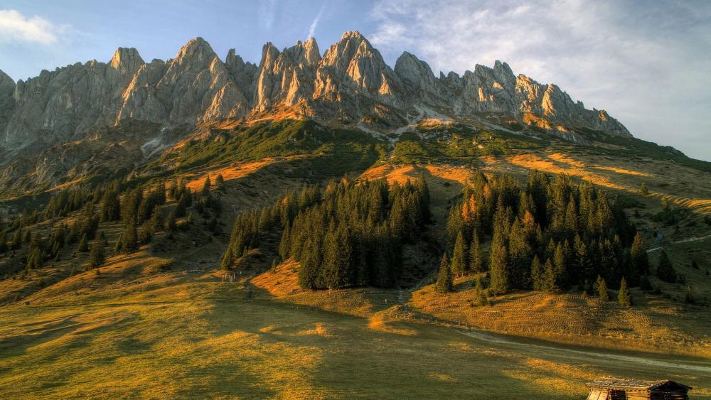 Majestic Mountain Peaks in Golden Sunset Light wallpaper