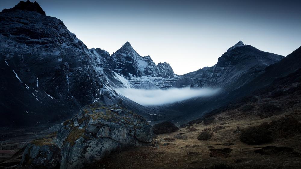 Majestic Mountain Peaks in Serene Atmosphere wallpaper