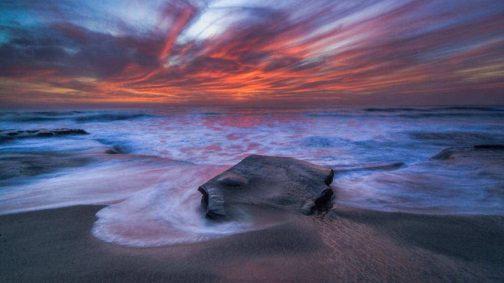 Tranquil Sunset Over the Ocean Shoreline wallpaper