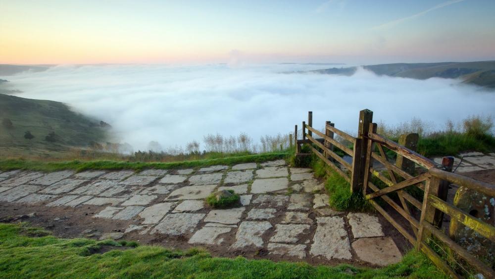 Serene Morning Mist Over Rolling Hills wallpaper