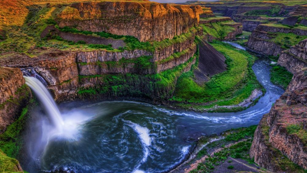 Majestic Waterfall in a Lush Canyon Landscape wallpaper