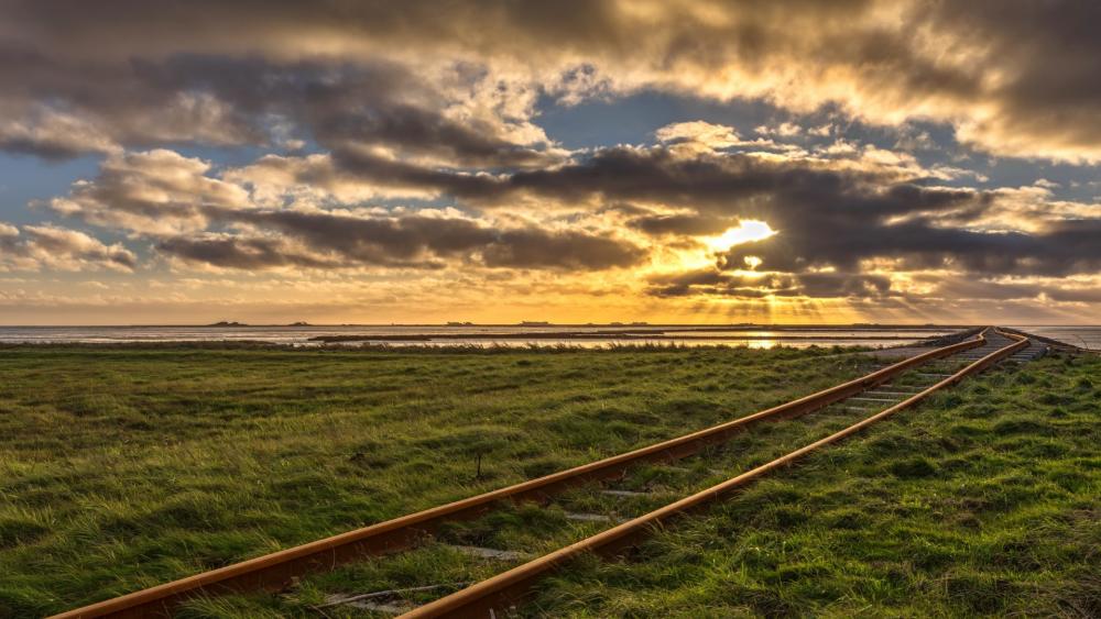 Golden Sunset Over Abandoned Railway Tracks wallpaper